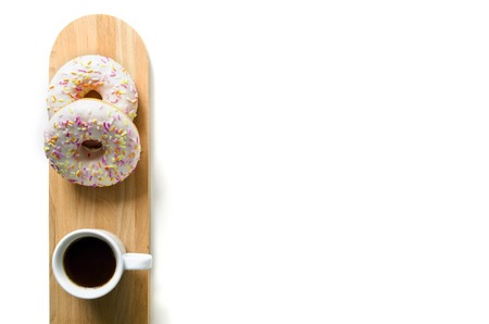 Donut and coffee on a serving wooden board. Beautiful design of the morning table or breakfast. Top view. Copy space. Mock-upの写真素材