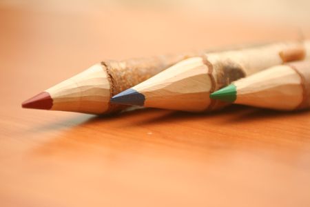 Three pencils lay on a tableの写真素材