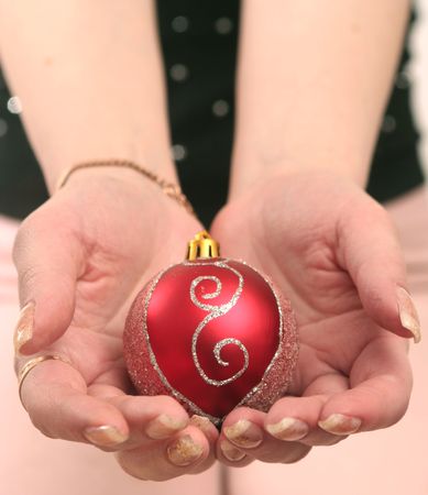 Red New Year's toy in female handsの写真素材