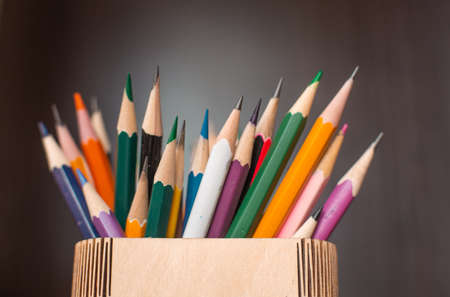a lot of sharp colored pencils for drawing on a dark backgroundの写真素材