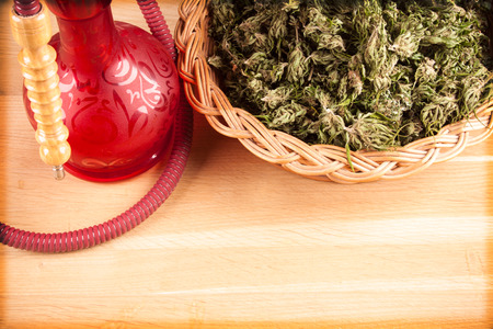 Red hookah on a wooden table