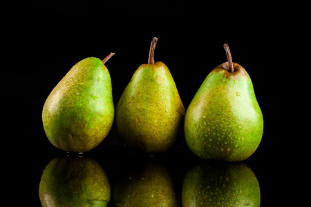 Juicy flavorful pears on a black backgroundの写真素材