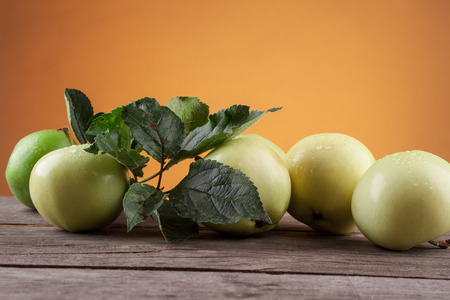 Summer green apple on the wooden tableの写真素材