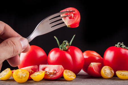 tomatoes on a black backgroundの写真素材