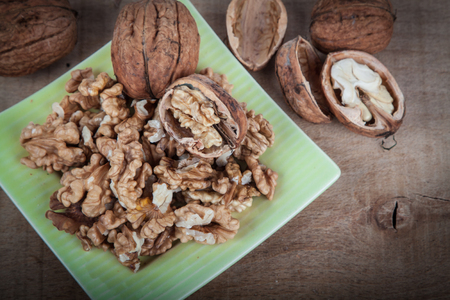 Walnuts (Juglans regia) on a wooden tableの写真素材