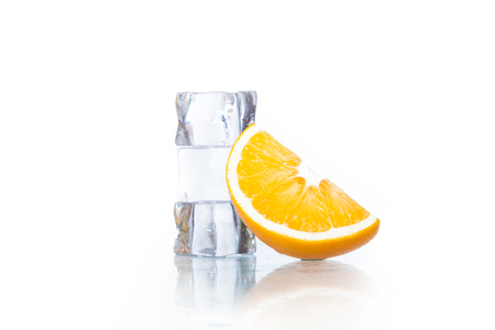ice cubes with oranges isolated on a white backgroundの写真素材