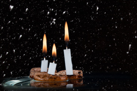 Christmas candles in walnut shell on water surfaceの写真素材