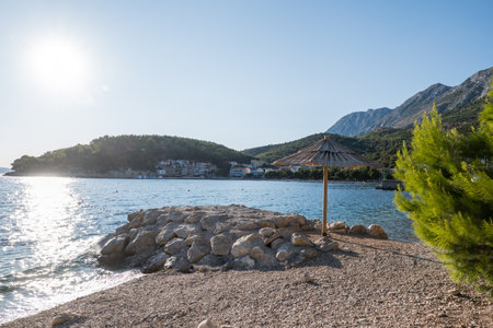 reed umbrella of the sea on the beach at sunriseの写真素材