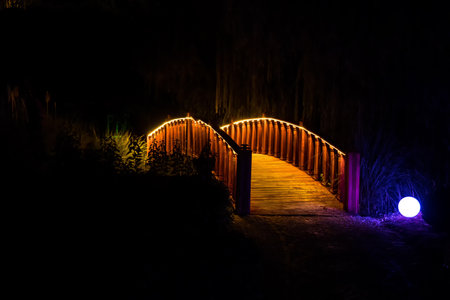 illuminated arched bridge in japanese gardenの写真素材