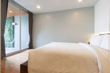 small white bedroom in apartment.