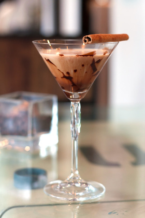 hot chocolate with cinnamon stick in tall wine glass.の写真素材