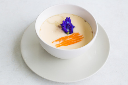 steamed egg garnished with butterfly pea flower and sliced carrot.の写真素材