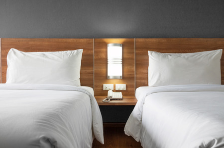 Twin bed with wood headboard.の写真素材