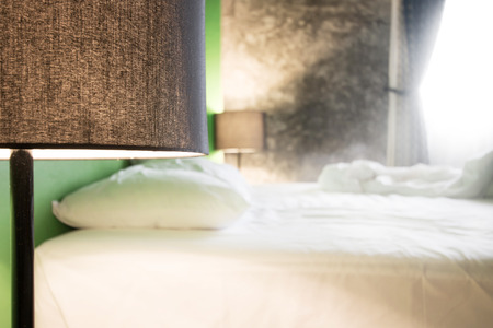 woke up in the morning and unmade bed. blurred backgroundの写真素材