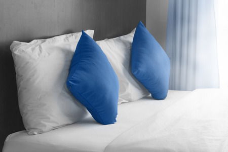 simply modern bedroom decorated with blue pillow.の写真素材