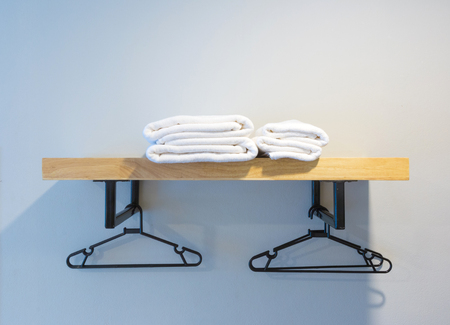 towel prepared on wood shelf and hanger.の写真素材