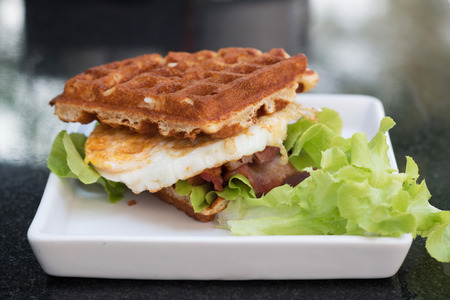 waffle with fried egg and bacon.の写真素材