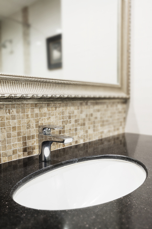 Black granite counter top , sink and faucet.の写真素材