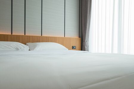 Zen style bedroom with wooden headboard, suitable for relaxation and health.の写真素材