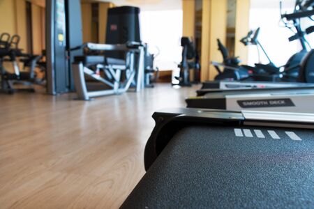 treadmill  and others equipment in small room gym, in apartment, blur background.