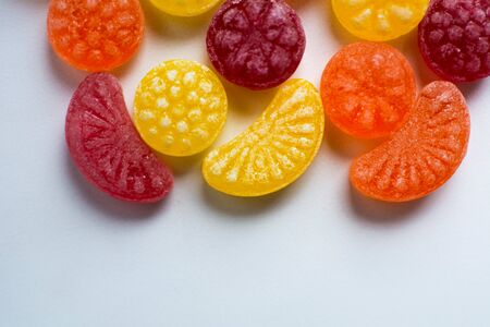 little fruit colored sweet lollipops isolated on white backgroundの写真素材