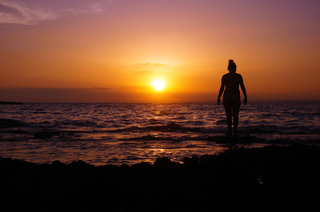Woman watching the sunset in Mallorca, Spainの写真素材