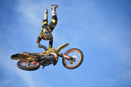 Motorcycle stunt in midair during a performanceの写真素材