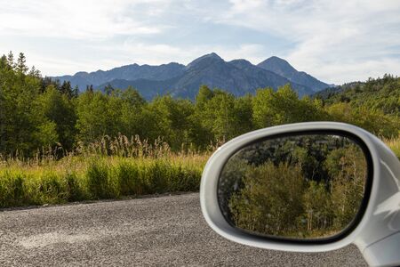 Scenic view of mountains and car rear view mirror.の写真素材