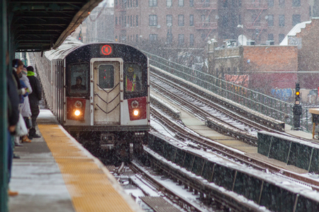 Bronx, NY/USA - December 14, 2013: Commuters wait for arriving number 4 train on a snowy day at the Mosholu Parkway station in the Bronx.のeditorial素材