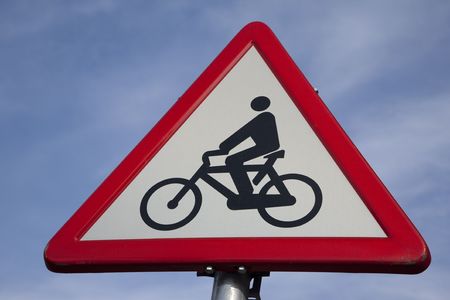 Red and White Bicycle Sign against Blue Sky Backgroundの写真素材