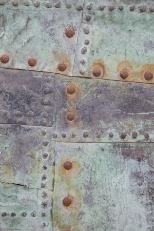 Close up of Green Metal Background with Rusty Nailsの写真素材