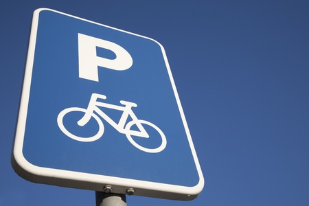 Bike Parking Sign against Blue Sky Background with Copy Spaceの写真素材