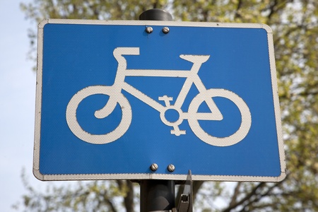 Blue Bike Lane Sign in Urban Setting の写真素材