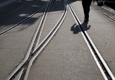 Railway Track and Man Walking into the Distanceの写真素材