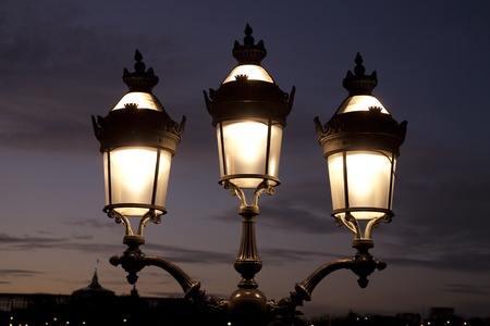 Lamppost illuminated at night in Paris, France