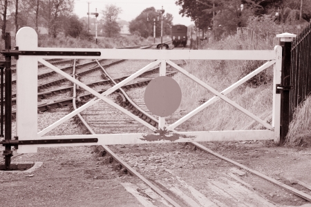 Railroad Tracks and Gate in Rural Area in Black and White Sepia Toneの写真素材