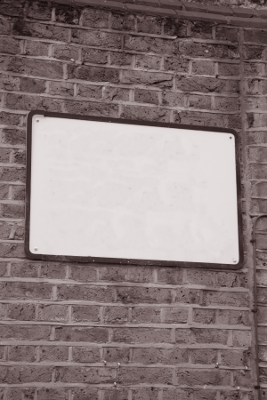 Empty Blank Sign on Brick Stone Wall in Black and White Sepia Toneの写真素材