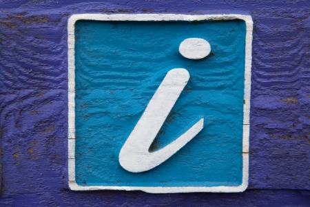 Blue Information Sign on Purple Wood Backgroundの写真素材