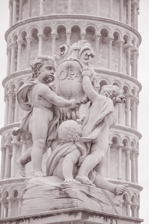 Fountain with Angels - Fontana dei Putti 18th Century and Leaning Tower of Pisa in Piazza dei Miracoli Square, Pisa, Italy in Black and White Sepia Toneの写真素材