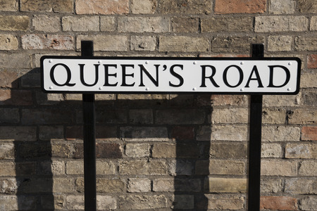 Queens Road Street Sign against Brick Wallの写真素材