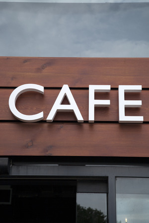 White Cafe Sign on Wooden Panel Backgroundの写真素材