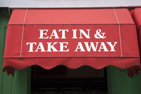 Eat In Or Take Away Sign on Red Backgroundの写真素材