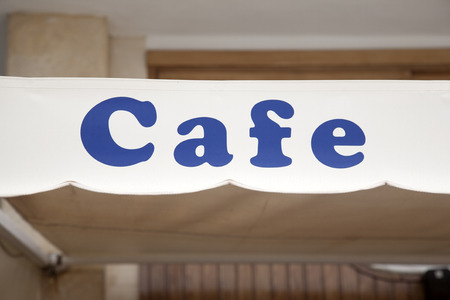 Blue Cafe Sign in Urban Settingの写真素材