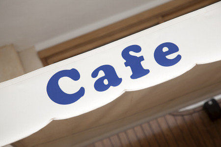 Blue Cafe Sign in Urban Settingの写真素材