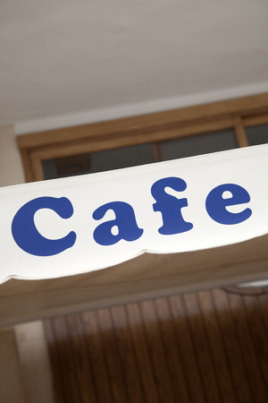 Blue Cafe Sign in Urban Settingの写真素材