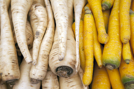 White and Yellow Parsnip Background on Market Stall