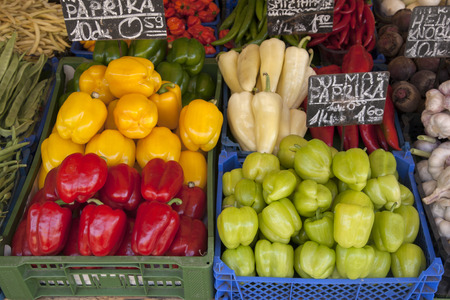 Green, Red and Yellow Pepper Background on Market Stallの写真素材