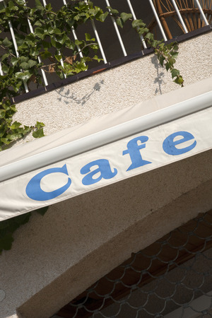 Cafe Sign against Building Backgroundの写真素材