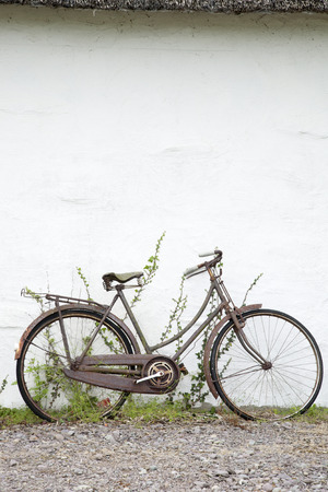 Old Bike against White Wallの写真素材