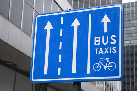 Blue Bus, Taxi and Bicycle Traffic Sign in Urban Settingの写真素材